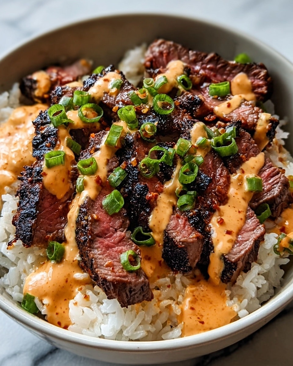 A bowl filled with three layers: the bottom layer is white cooked rice with a soft and slightly shiny texture, the middle layer is sliced grilled steak pieces with a dark charred crust and a tender pink inside, arranged closely together, and the top layer is a creamy orange sauce drizzled unevenly over the steak, garnished with small pieces of chopped green onions. The bowl is white, and it sits on a white marbled surface. photo taken with an iphone --ar 4:5 --v 7