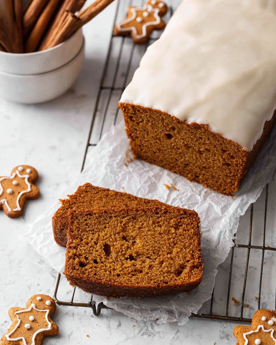 The image shows a slice of brown gingerbread loaf with a moist and crumbly texture placed on white parchment paper over a metal cooling rack. The loaf is partially frosted with a thick layer of white glaze on one side. Around the loaf, there are five small gingerbread cookies shaped like little people, scattered on a white marbled surface. In the top left corner, there is a white bowl filled with cinnamon sticks. Photo taken with an iphone --ar 4:5 --v 7