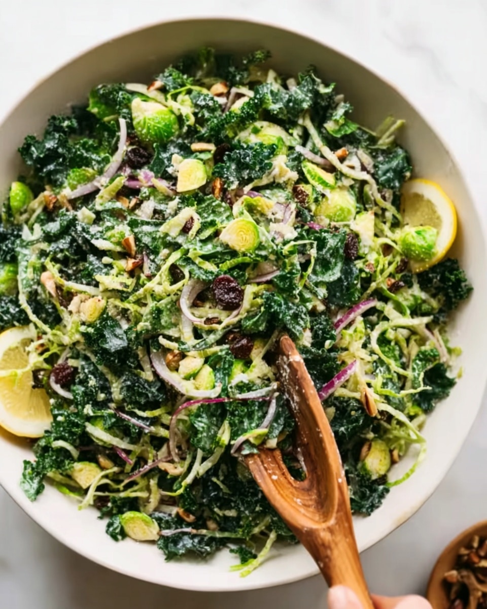 A fresh salad in a white bowl sitting on a white marbled surface, with two wooden salad spoons mixing it. The salad has multiple layers: the base is dark green kale leaves, mixed with small bright green Brussels sprouts slices and thin light purple onion rings. There are small light brown nuts scattered on top, adding texture. The colors are vibrant and fresh, with the contrasting greens, purples, and browns clearly visible. Photo taken with an iphone --ar 4:5 --v 7