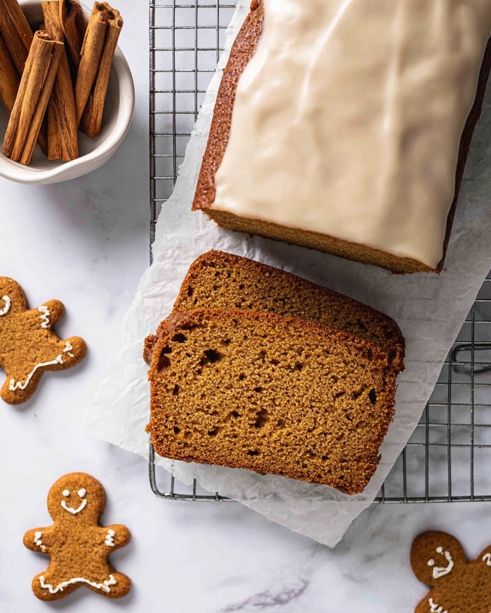 The image shows a loaf of brown spice cake with one thick slice cut and placed on white parchment paper over a metal cooling rack. The slice has a moist, slightly crumbly texture with small air holes visible inside. The rest of the loaf is partially covered with smooth, shiny, light beige icing on top, while the bottom crust is darker brown. Around the cake, small gingerbread man cookies are scattered on a white marbled surface. To the top left corner, a white bowl holds several cinnamon sticks standing upright. Photo taken with an iphone --ar 4:5 --v 7