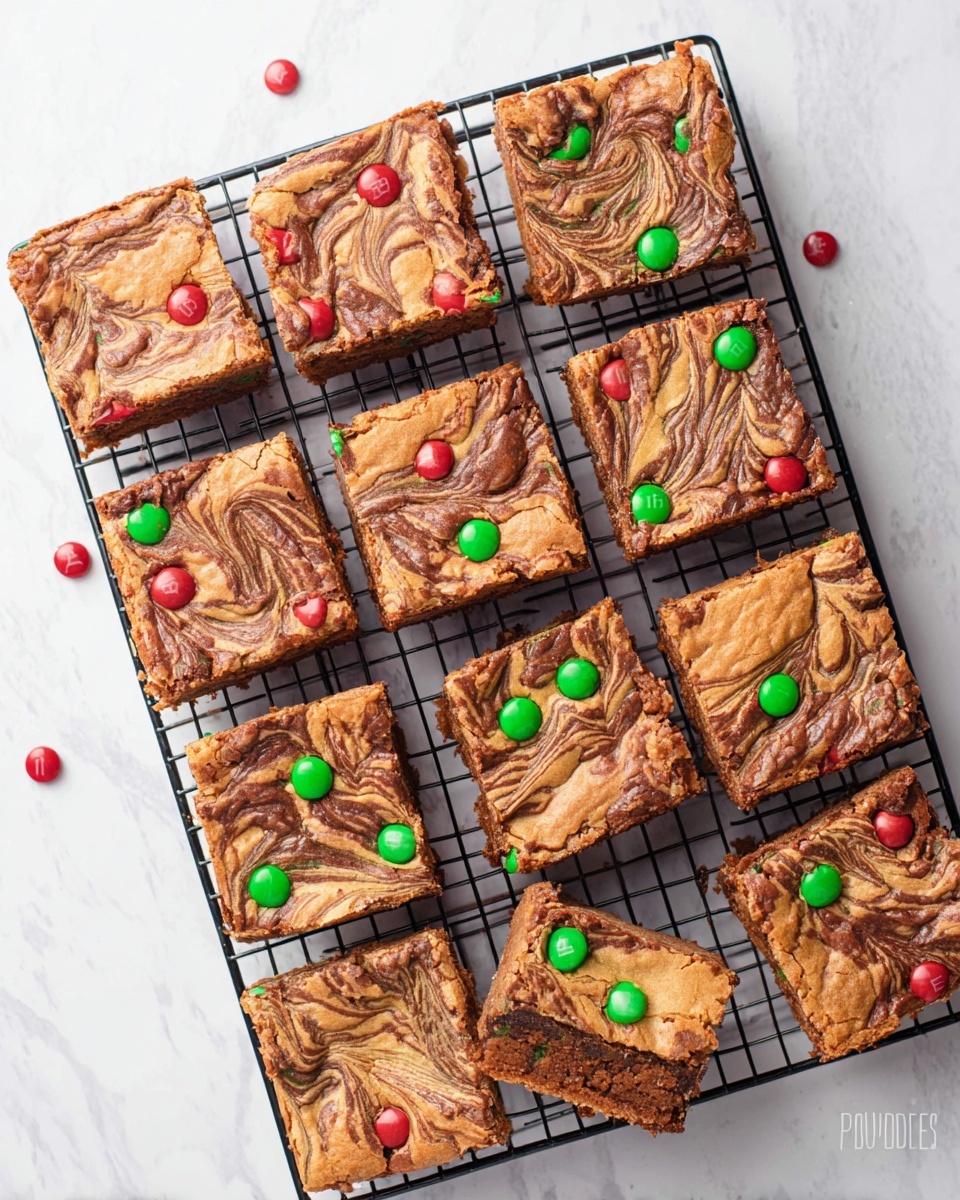 Twelve square pieces of swirled brownies sit on a black cooling rack over a white marbled surface, each piece showing a top layer with light brown and dark chocolate swirl patterns creating a textured look. Red and green candy-coated chocolates are scattered sparsely on the surface of several brownies. The brownies have a slightly rough crust with a dense, moist inside visible on a few edges, and all pieces are evenly cut, with one piece missing from the bottom right corner. Photo taken with an iphone --ar 4:5 --v 7