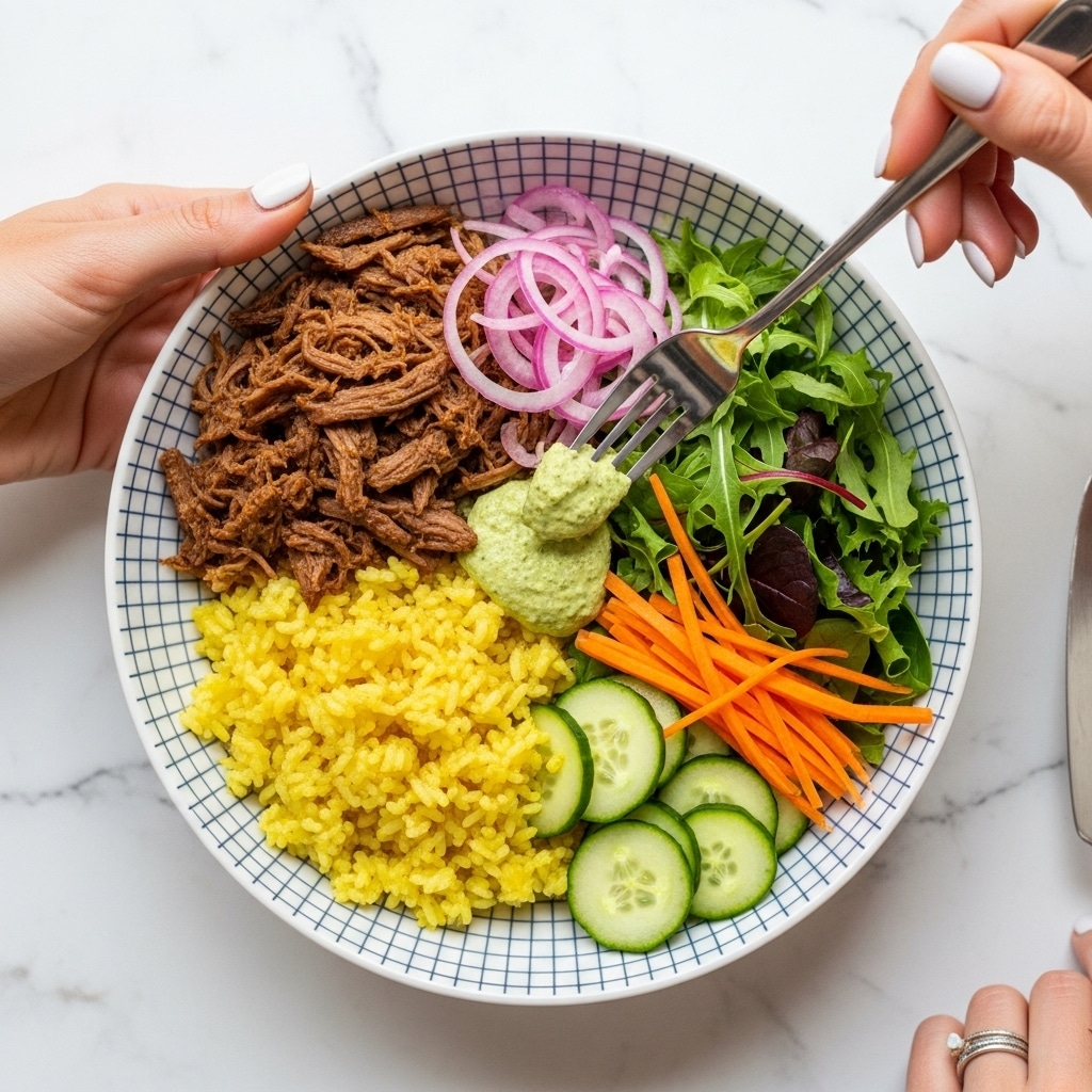 A white bowl with a dark blue grid pattern holds a colorful dish with four main layers: shredded brown meat on the top left, fluffy yellow rice on the bottom left, fresh mixed greens with sliced cucumber and orange carrot on the right, and thinly sliced pink onions in the middle on top. There is also a dollop of green sauce spread over the rice near the center. A woman's hand with white nail polish is holding the bowl from the left side, while another woman's hand with a ring is using a fork to scoop some green sauce. The background is a white marbled texture. photo taken with an iphone --ar 4:5 --v 7