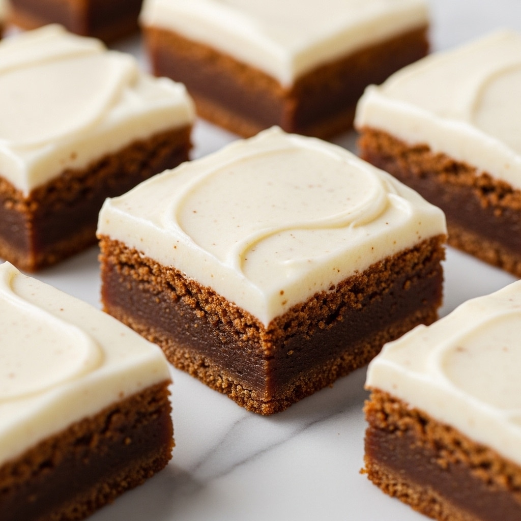 The image shows several square dessert bars placed on a white marbled surface. Each bar has two layers: the bottom layer is thick, brown, and dense with a slightly textured look, while the top layer is a thick, creamy white frosting that appears smooth with tiny specks of spices or vanilla. The bars are neatly cut into even portions, and the focus is on one central bar with others slightly blurred in the background, showing the clear contrast between the brown base and soft white topping. photo taken with an iphone --ar 4:5 --v 7