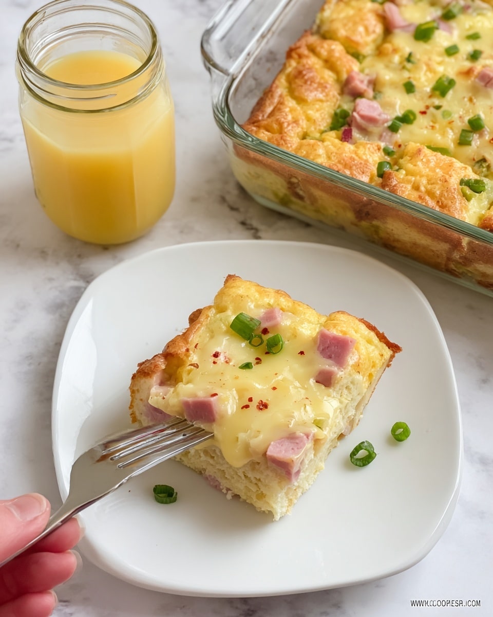 A white plate holds a square piece of a baked breakfast casserole with three layers: a golden brown bread base with a soft, airy texture; a middle layer of pink ham chunks; and a top layer of creamy yellow cheese sauce sprinkled with small green chopped scallions and light red spice powder. Next to the plate is a fork and a woman's hand holding the fork. Behind this, there is a clear glass baking dish with more of the casserole visible, showing the same layers. To the right of the dish is a clear glass jar filled with light orange juice. The background is a white marbled surface. photo taken with an iphone --ar 4:5 --v 7